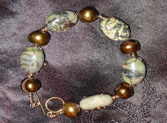Bracelet Wire wrapped yellow turquoise with gold cultured freshwater pearls.  Both the wire and
